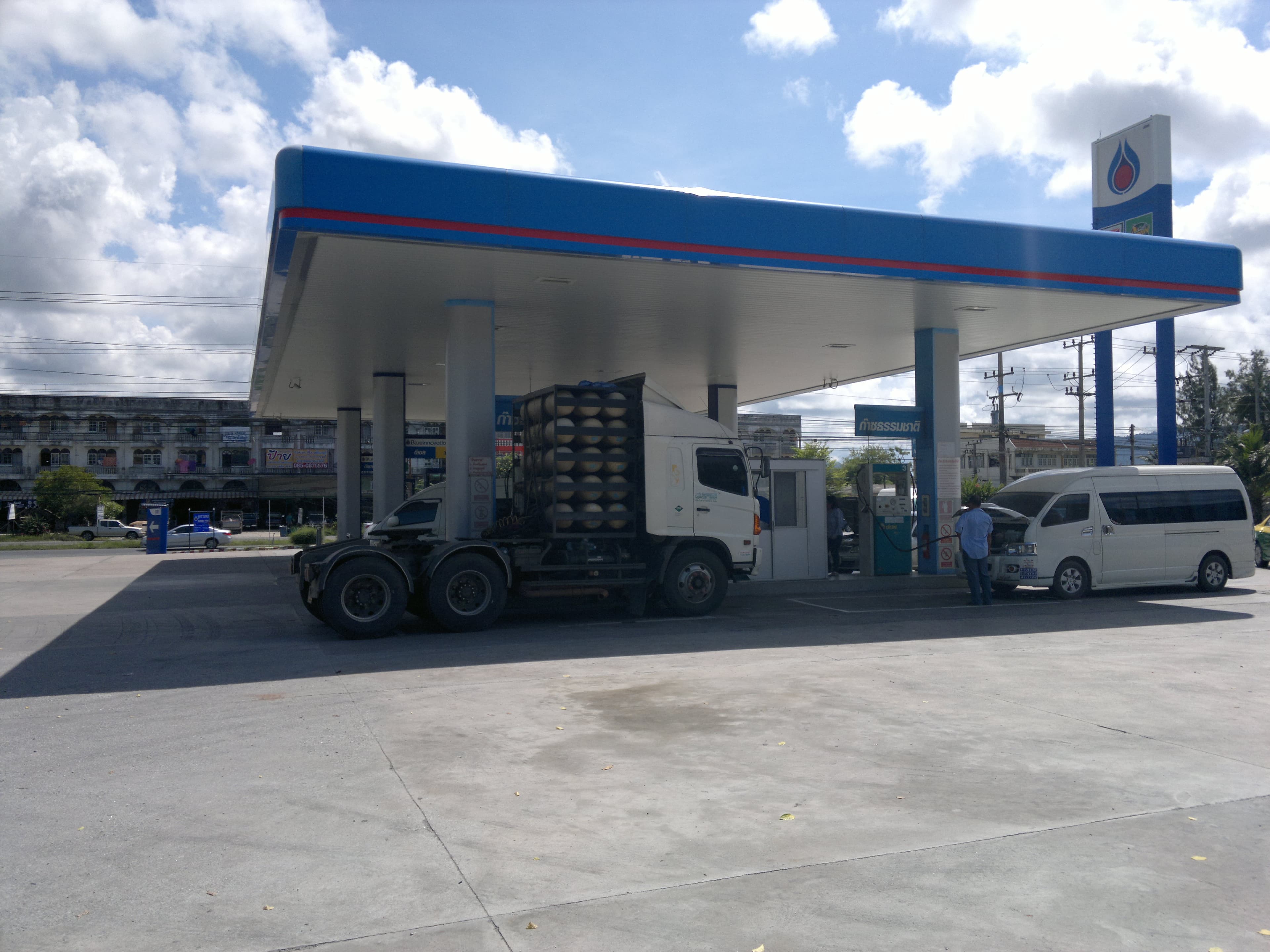 A commercial CNG truck refuelling at a natural gas station